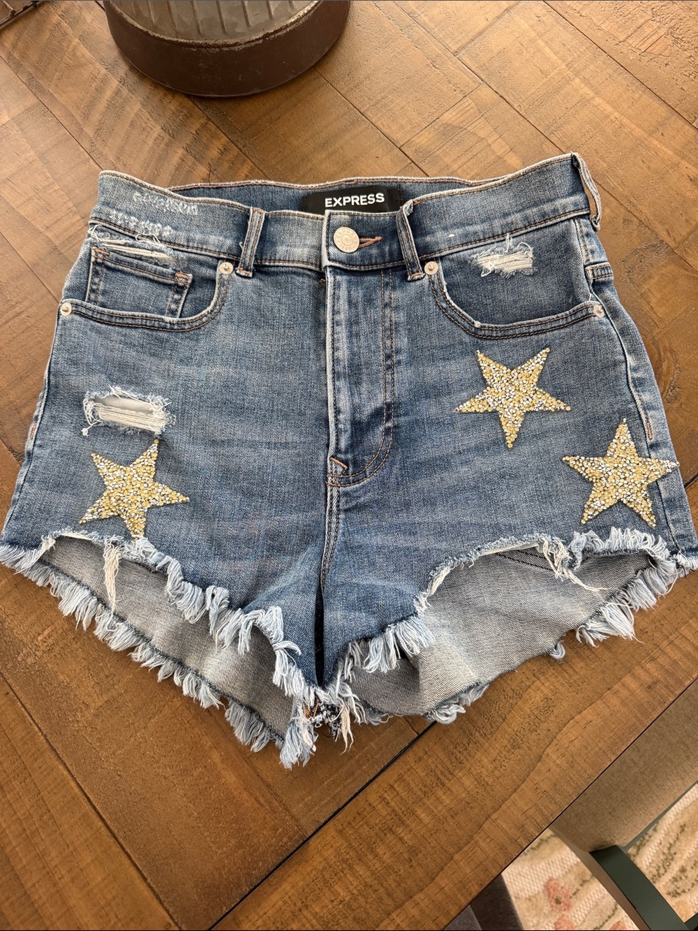 Express Blue Distressed Denim Shorts with Gold Star Embellishments